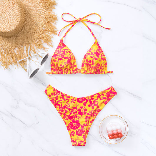 Woman wearing a black and white floral print triangle cup bikini swimsuit on a sunny beach. - Image 4