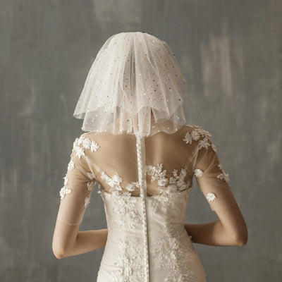 White multi-layer short bridal veil with gold star embellishments, worn by a model in a white lace wedding dress. - Image 4