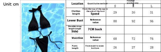 Woman in a black ribbed one-piece bikini with a halter neck and criss-cross tie details, posing against a textured wall. - Image 6