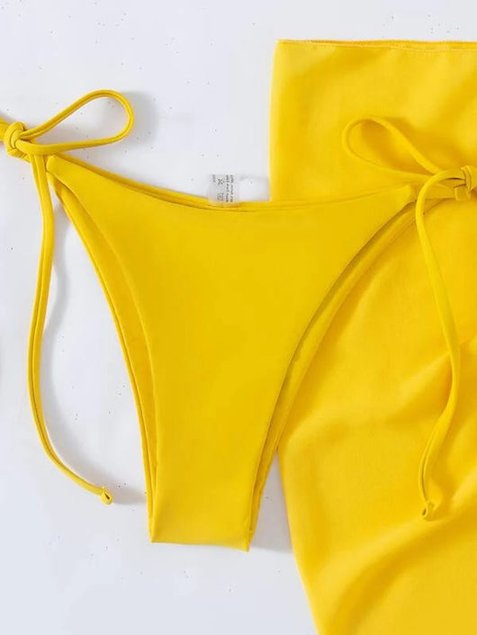 Neon yellow three-piece bikini set with triangle cup lace-up top, tie-side bottom, and matching sarong, displayed with a straw hat and sunglasses. - Image 17
