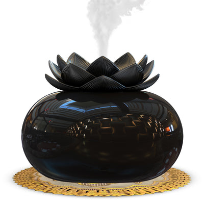 Black spherical aromatherapy humidifier with a lotus flower top, emitting mist, sitting on a gold decorative doily. - Image 4