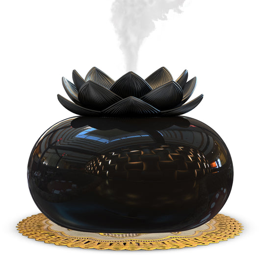 Black spherical aromatherapy humidifier with a lotus flower top, emitting mist, sitting on a gold decorative doily. - Image 4