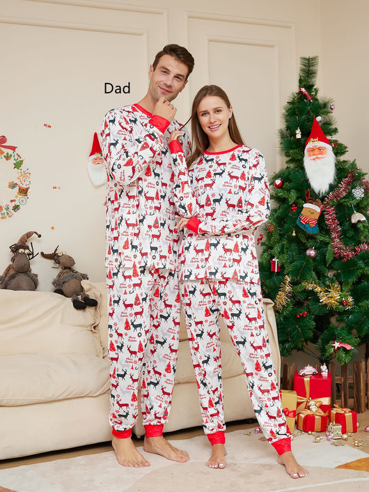Young girl in white Christmas pajamas with red deer and tree print, red trim, standing by a decorated tree. - Image 6