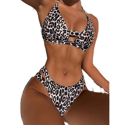 Leopard print high-waisted bikini with a halter neck top and front cutout, worn by a woman lounging outdoors. - Image 5
