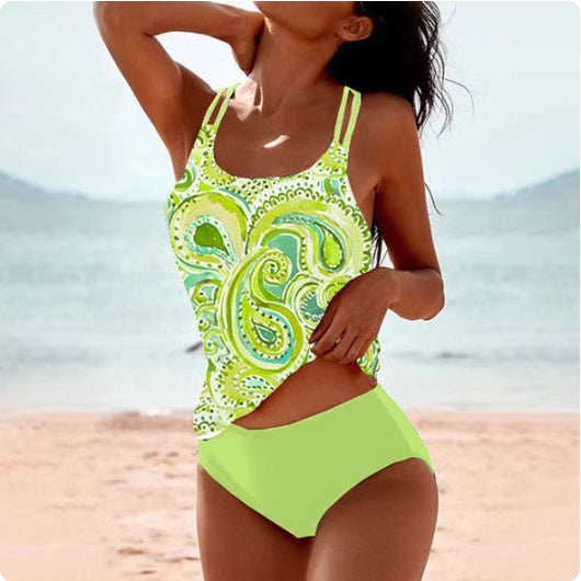 Woman wearing a red retro split high waist tankini swimsuit with an ornate mandala print top on a beach. - Image 14