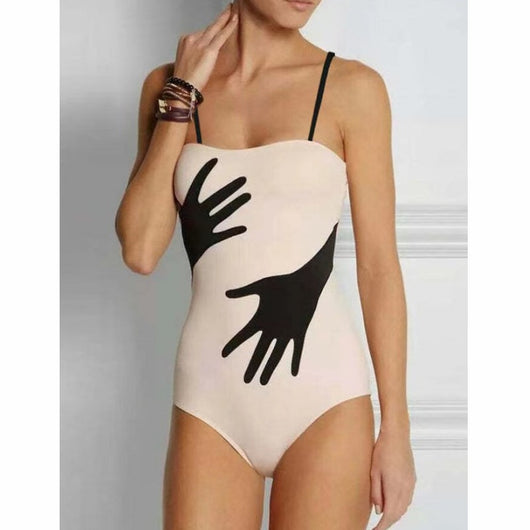Women's light pink one-piece bikini with black handprint pattern and matching tie-waist sarong. - Image 9