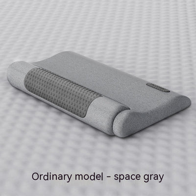 Dark gray cervical spine pillow with light gray textured massage area and power button on a light gray surface. - Image 4