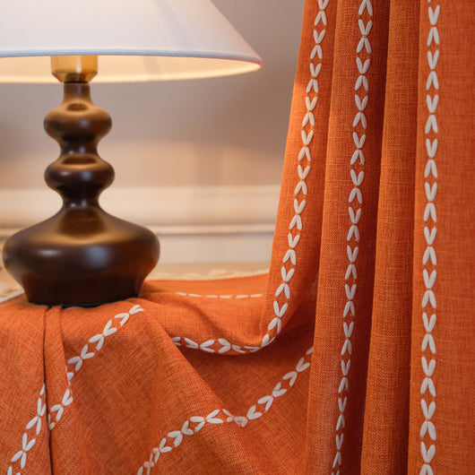 Black polyester curtain with white jacquard multi-line pattern and black tassels, draped over a white chair. - Image 32