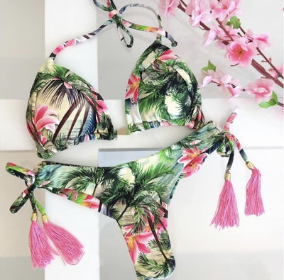 Women's tropical floral print bikini with a halter top, ruffled edges, and tie-side bottoms with pink tassels. - Image 24