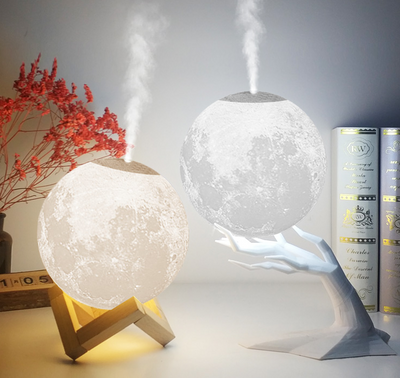 Moon-shaped humidifier and night light with a white deer stand, emitting mist, on a wooden table with books. - Image 7