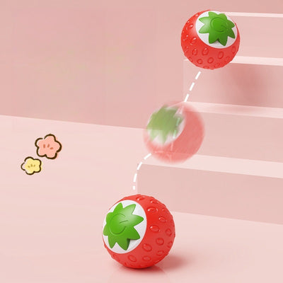 Green electric pet toy ball with a textured surface and a white strawberry-like design featuring a power button. - Image 4