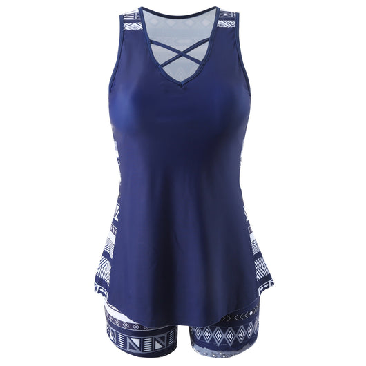 Women's navy blue tankini swimsuit with geometric pattern, criss-cross V-neck, and matching swim shorts. - Image 7