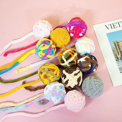 Colorful plush wool ball cat toys with long yarn tails, featuring various patterns and a bell inside for play. - Image 10