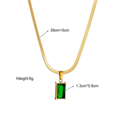 Gold hoop earrings with rectangular emerald green zircon pendants, displayed on a light beige fabric. - Image 13