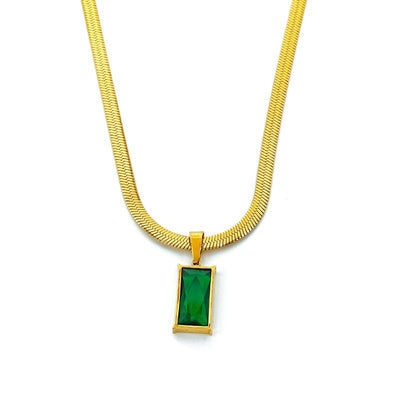 Gold hoop earrings with rectangular emerald green zircon pendants, displayed on a light beige fabric. - Image 5