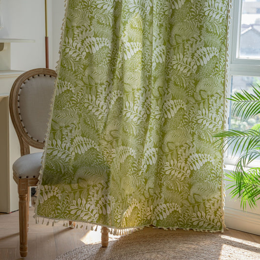 Green curtain with white leafy botanical pattern and cream tassels, hanging in a window with natural light. - Image 10