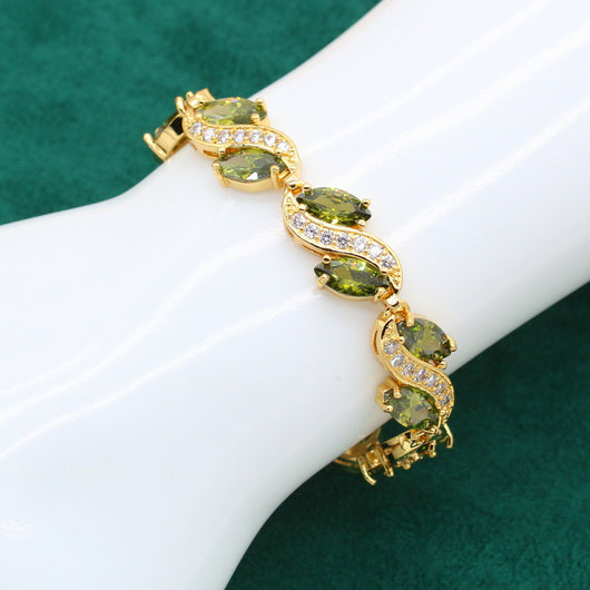 Gold-toned jewelry set with green marquise gemstones and clear accents, including a bracelet, necklace, earrings, and ring. - Image 9