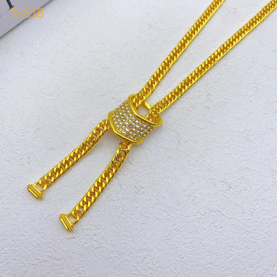 Gold-plated four-piece jewelry set with teardrop rhinestone necklace, bracelet, earrings, and ring on red velvet stands. - Image 13