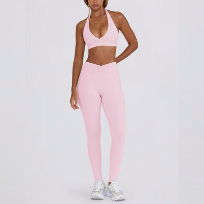 Light pink halter neck sports bra and high-waisted leggings workout set on a model. - Image 20