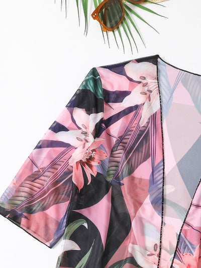 Woman in a three-piece bikini swimsuit set with a black tube top, floral boy shorts, and a sheer floral kimono cover-up. - Image 11