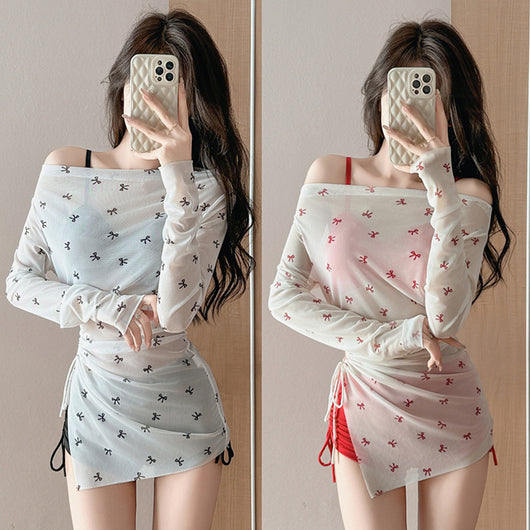 Women's three-piece swimwear with a black bikini and a sheer white off-shoulder long-sleeve bow print cover-up. - Image 2