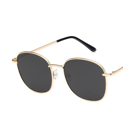 Gold metal round sunglasses with dark gray resin lenses and black temple tips on a white background. - Image 5