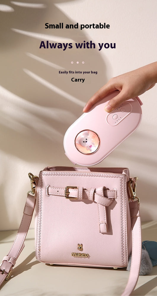 Dark green paw-shaped hand warmer and power bank with a cute bear design, held in a hand with white faux fur gloves. - Image 13