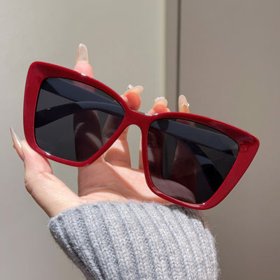 Clear large-frame square glasses held by a hand in a grey knitted sweater, showcasing the transparent plastic frame. - Image 6