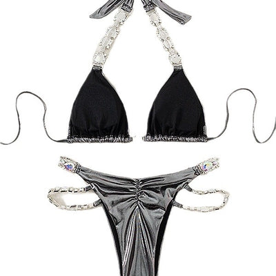 Shiny blue two-piece bikini with rhinestone-embellished halter top and high-cut bottom, laid flat with a straw hat and sunglasses. - Image 5