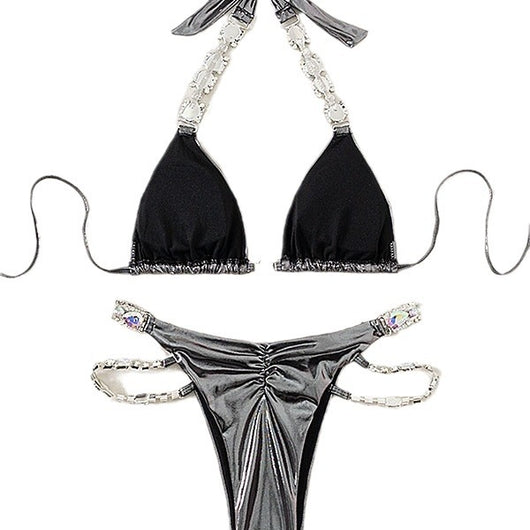Shiny blue two-piece bikini with rhinestone-embellished halter top and high-cut bottom, laid flat with a straw hat and sunglasses. - Image 5