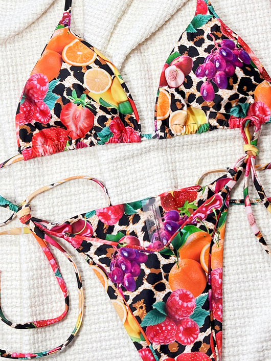 Women's separated bikini with a vibrant fruit and leopard print, featuring a halter-neck top and tie-side bottom. - Image 9