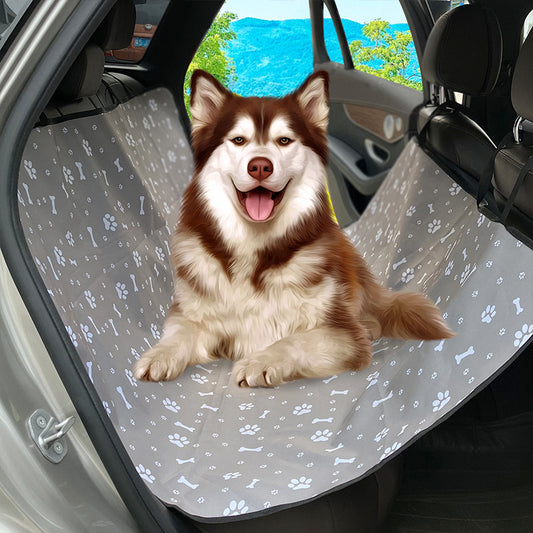 Pink car pet mat with white paw print and bone patterns, featuring black straps for securing to a rear seat.