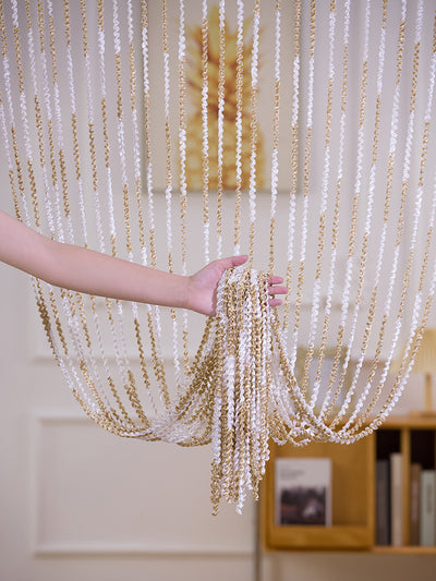 Brown and beige striped string curtain with twisted tassel texture, held by a hand, for living room partition. - Image 10