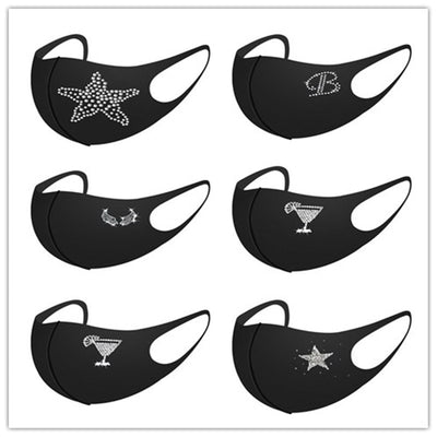 Black face mask with a white rhinestone 'Queen' text and crown design, featuring ear loops.