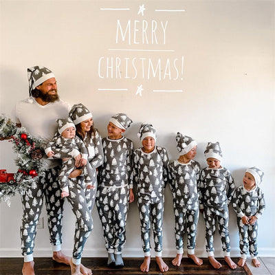 Family of seven and a dog in matching grey Christmas tree print pajamas with white cuffs and beanies. - Image 3