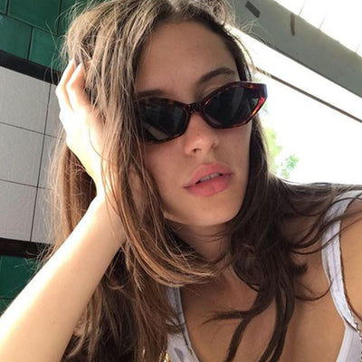 Angular cat-eye sunglasses with a tortoiseshell frame, brown gradient lenses, and gold jumping cheetah temple details. - Image 3
