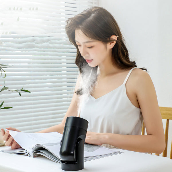 Pink portable USB humidifier with a cylindrical design and a rotating base, measuring 155mm tall.