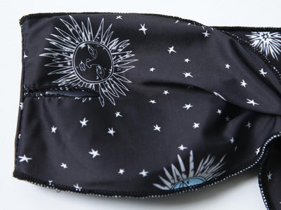 Black celestial print bikini set with a bandeau tie-front top and high-cut bottoms, featuring sun, moon, and star patterns. - Image 9