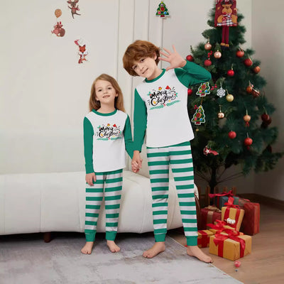 Family of four wearing matching green and white striped Christmas pajamas with "Merry Christmas" graphic. - Image 3