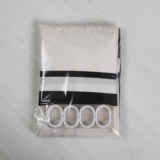 Black and white striped polyester shower curtain with a crown and text design, hanging from a silver tension rod. - Image 8