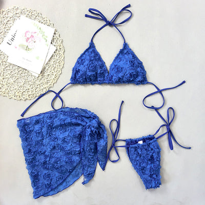 Red three-piece bikini set with a halter top, tie-side thong bottom, and sarong, all featuring a raised floral pattern. - Image 9