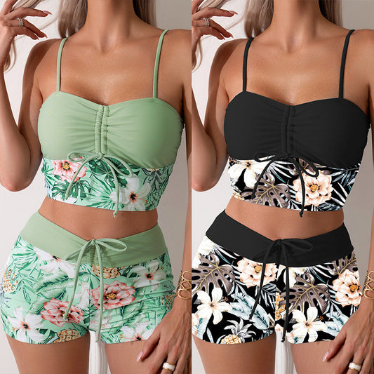 Women's light green two-piece bikini swimsuit with tropical floral and pineapple print, featuring drawstring top and shorts.