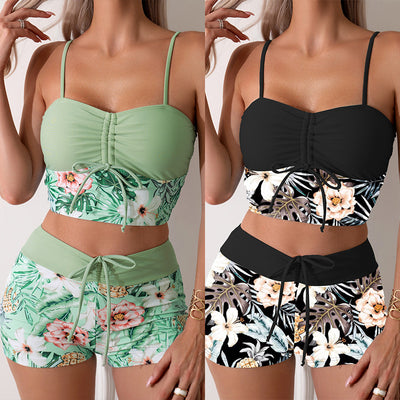 Women's light green two-piece bikini swimsuit with tropical floral and pineapple print, featuring drawstring top and shorts.