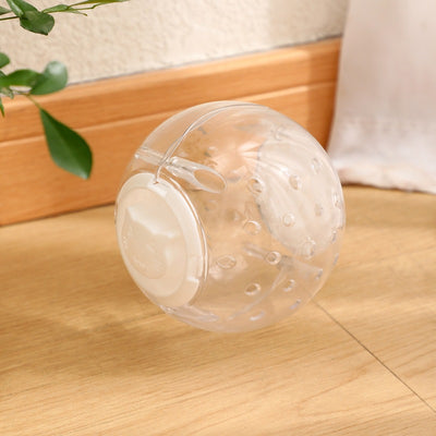 Clear plastic pet tumbler food leakage toy with blue accents and a cat face design, on a wooden floor. - Image 6