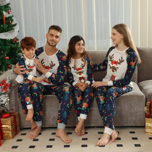 Family Christmas pajamas with a cartoon reindeer wearing a Santa hat and red scarf on a black top, and dark blue pants with a repeating reindeer and holly patte - Image 23