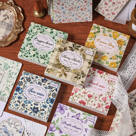 Purple Whisper decorative paper set with 100 sheets, featuring various purple floral, butterfly, and geometric patterns.