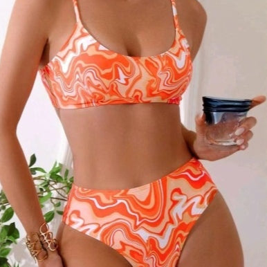 Red, orange, and white abstract swirl print three-piece bikini set with matching shorts, shown with a straw hat and sunglasses. - Image 3