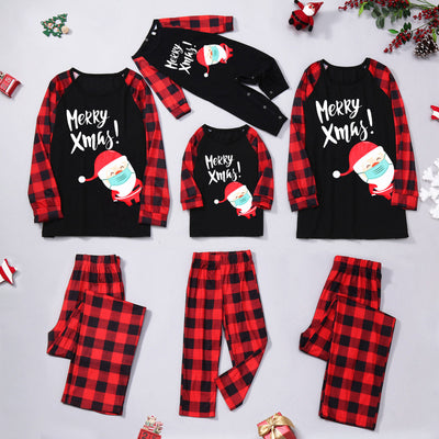 Family matching Christmas pajamas with black tops, red plaid sleeves, and Santa wearing a mask, paired with red plaid pants. - Image 21