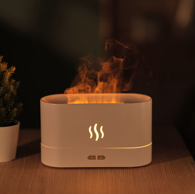 Black aroma diffuser with purple flame light effect and mist, featuring control buttons and a flame icon. - Image 9