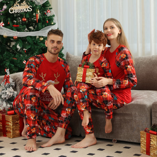 Family matching red Christmas pajamas with a cartoon reindeer and "Merry Christmas" text on a plaid background. - Image 21